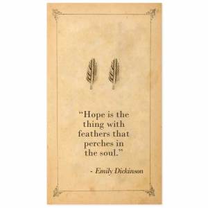Gold-tone feather stud earrings on an Emily Dickinson quotation card.