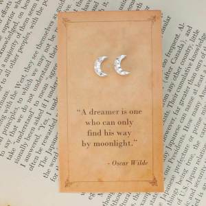 Textured silver-tone crescent moon stud earrings on an Oscar Wilde quotation card.