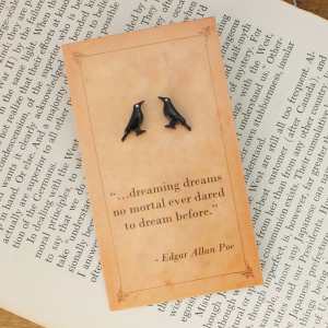 Black raven stud earrings displayed on an Edgar Allan Poe quotation card.