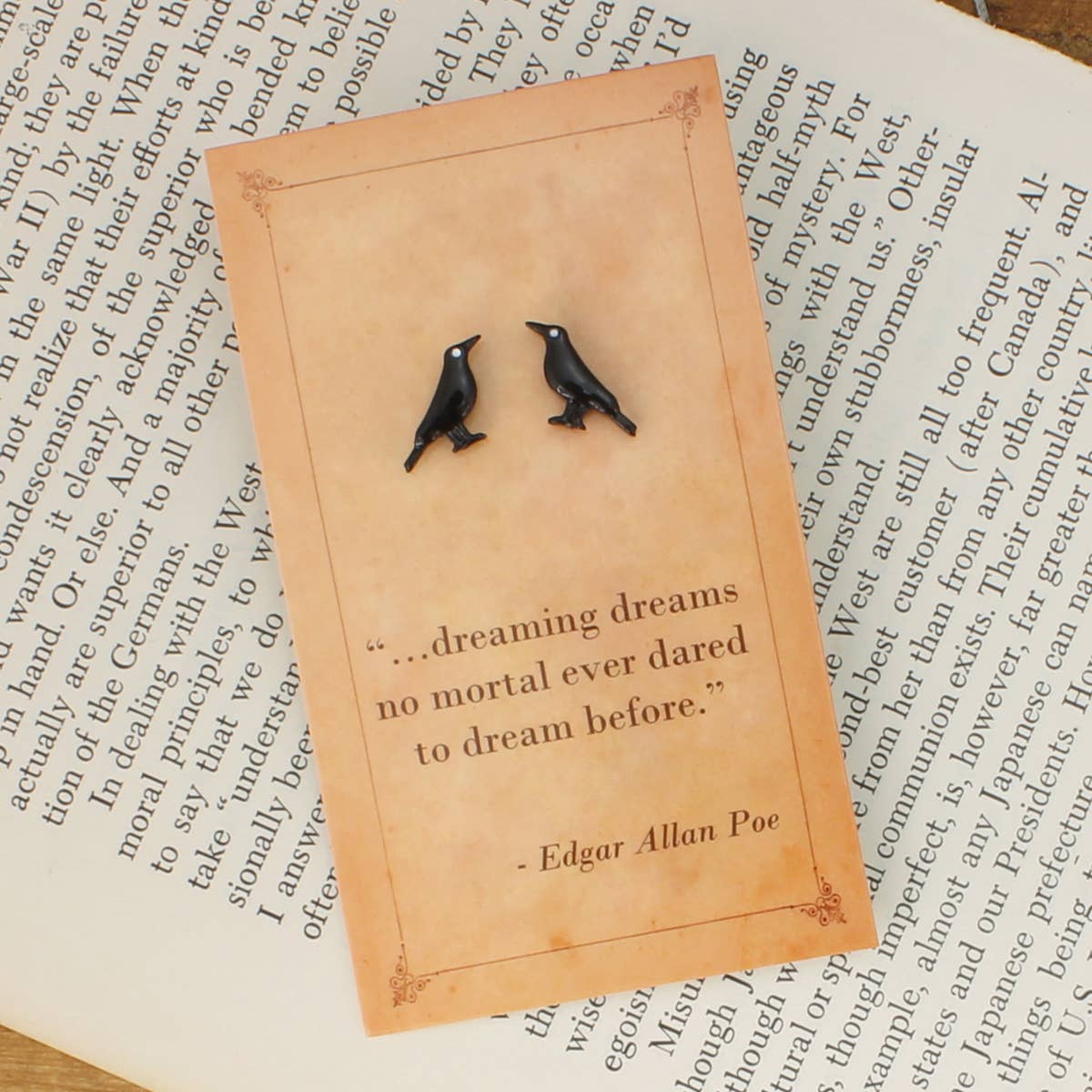 Black raven stud earrings displayed on an Edgar Allan Poe quotation card.