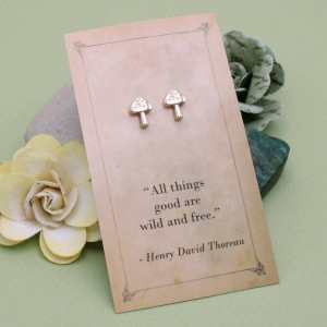 Gold-tone mushroom stud earrings displayed on a Henry David Thoreau quotation card.