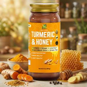 Glass jar of turmeric honey beside turmeric, ginger and honeycomb.